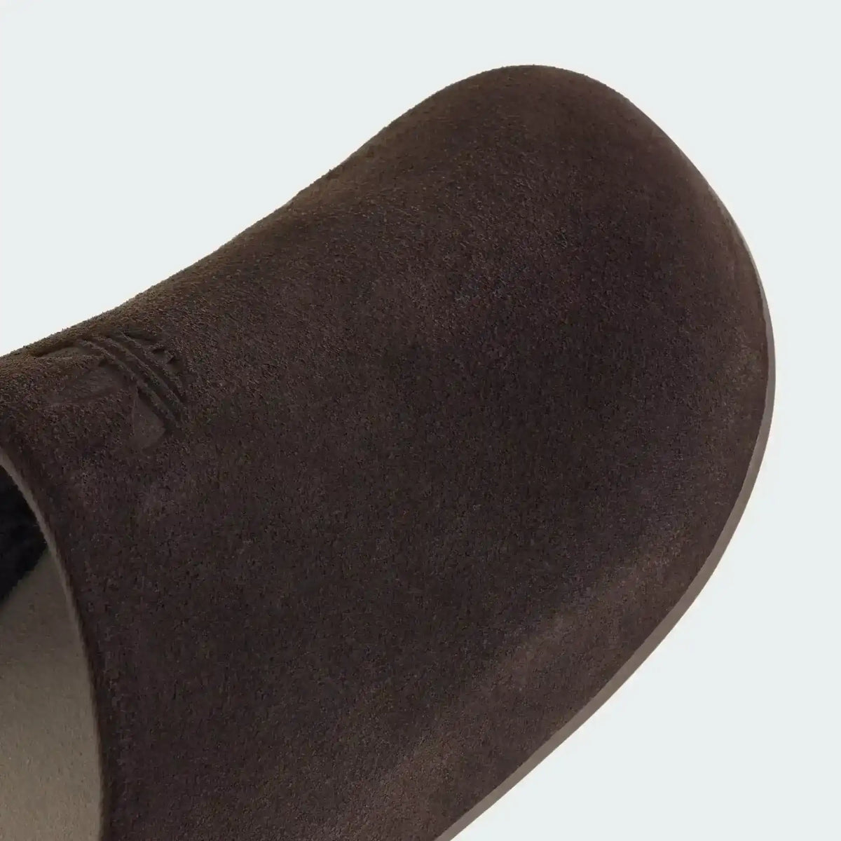 Closed-toe backless slide shoes with contrasting footbeds.