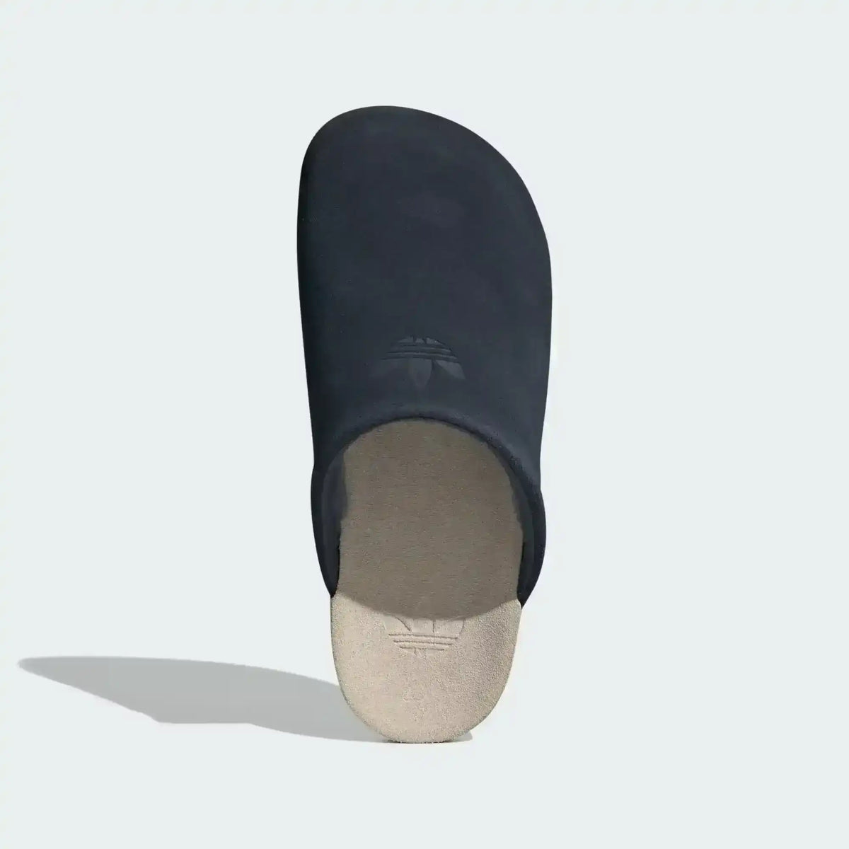 Closed-toe backless slide shoes with contrasting footbeds.