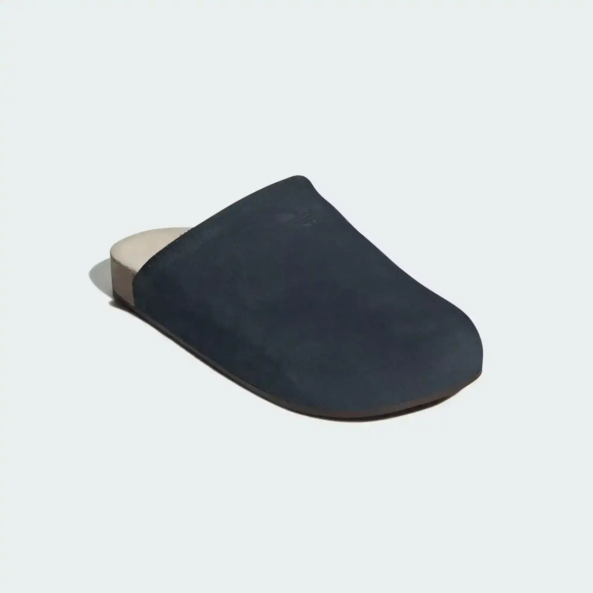 Closed-toe backless slide shoes with contrasting footbeds.