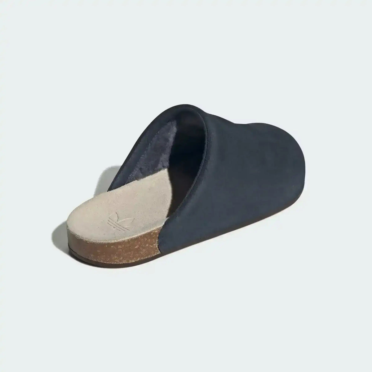 Closed-toe backless slide shoes with contrasting footbeds.
