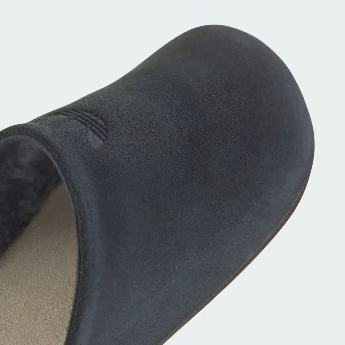 Closed-toe backless slide shoes with contrasting footbeds.