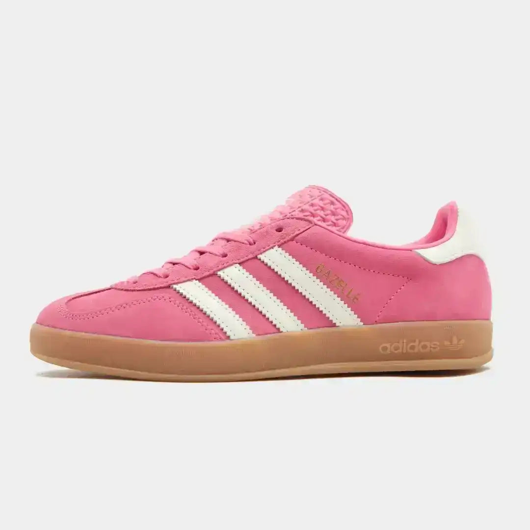 Adidas Gazelle sneaker shown in side profile, featuring the classic low-top Gazelle silhouette with suede-style upper, iconic three-stripe branding, and a traditional gum outsole.