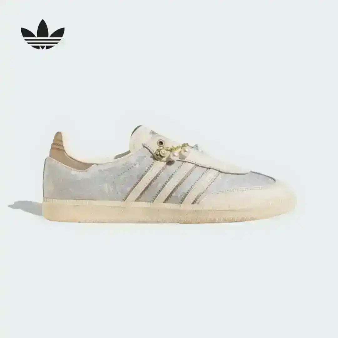 Cream and pale green low-top sneaker, side view.