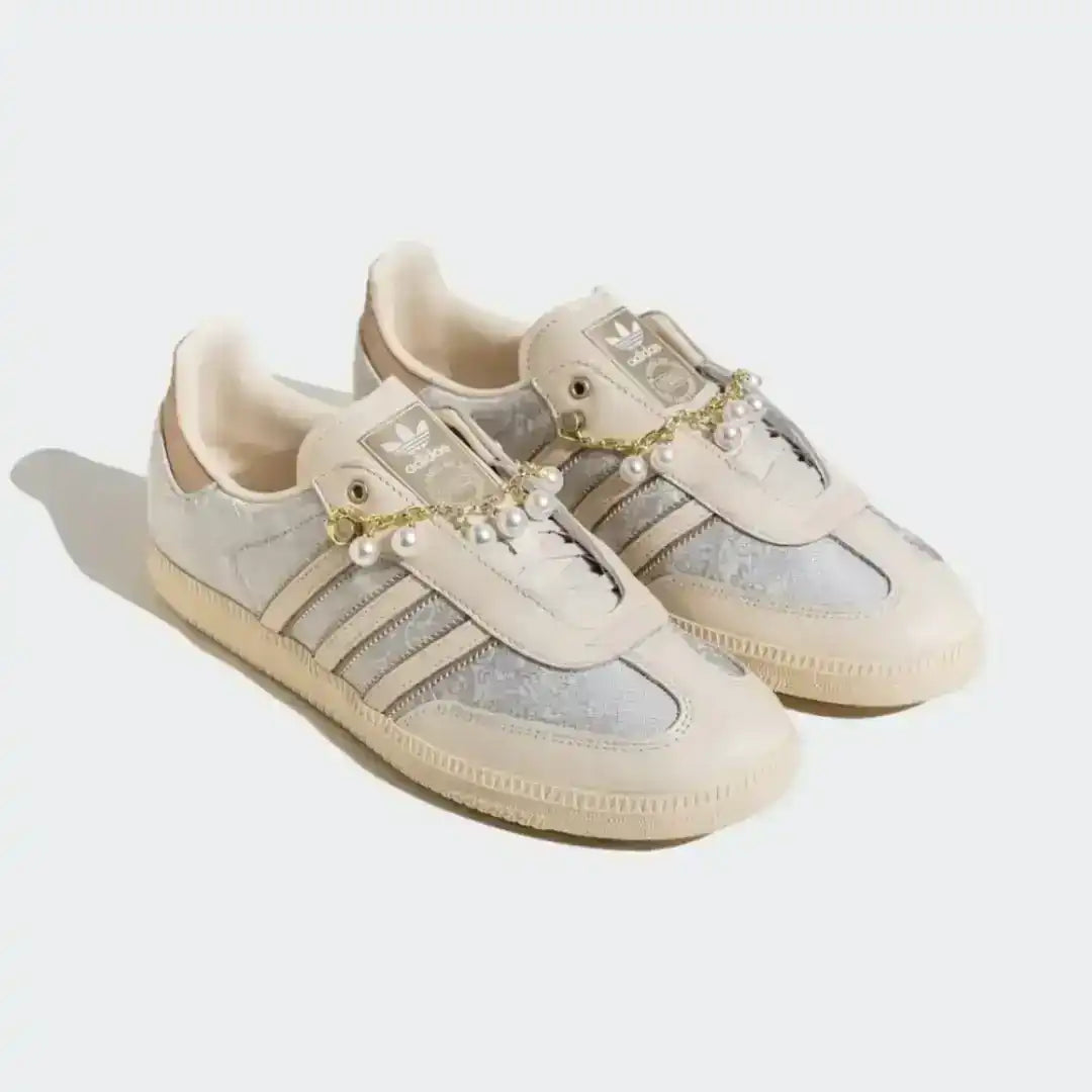 Adidas beige sneakers featuring pearl and gold chain detailing, textured side panels, soft leather construction and a luxury lifestyle aesthetic.