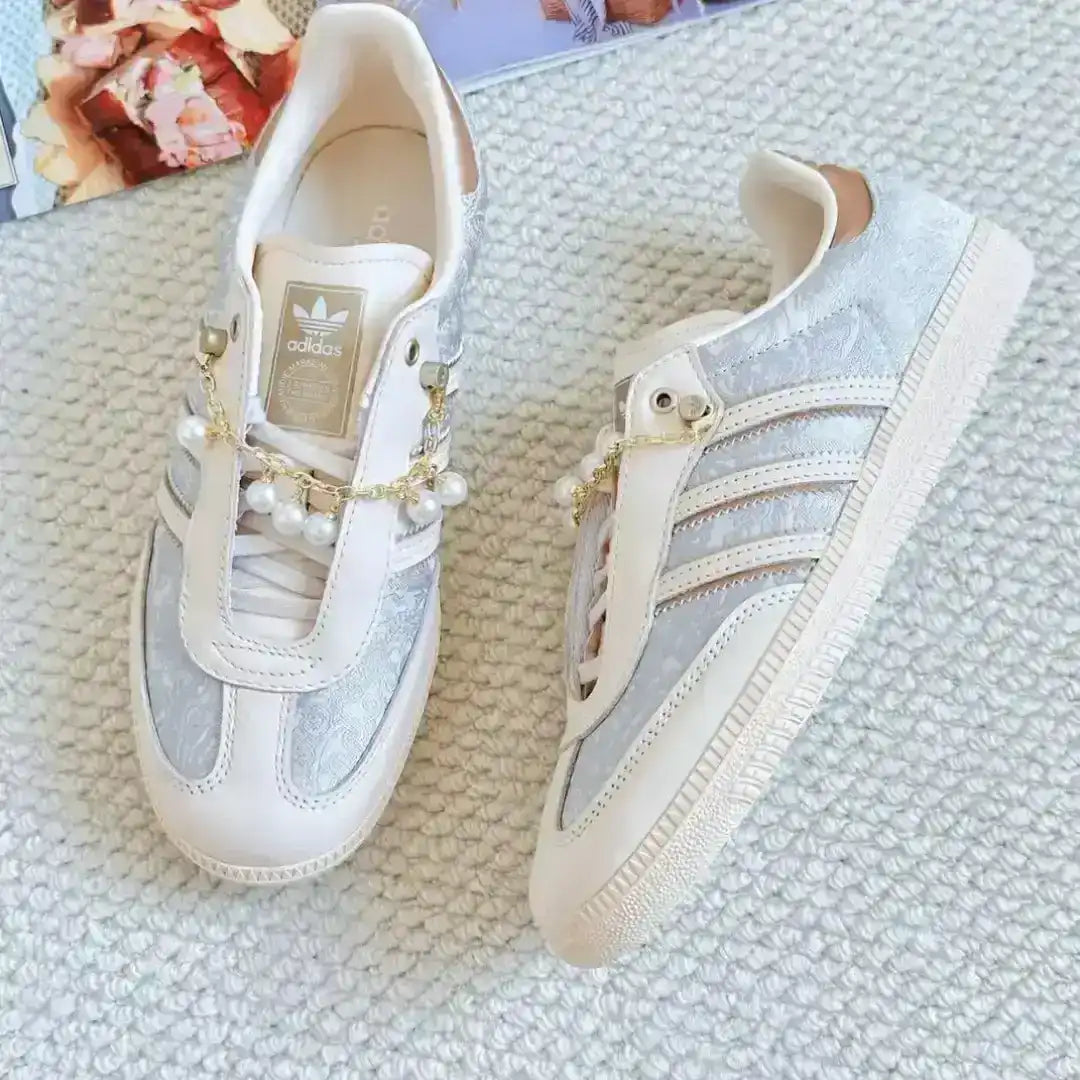 Adidas beige sneakers combining pearl chain embellishments, textured side inserts and leather accents to deliver a soft and luxurious street style.