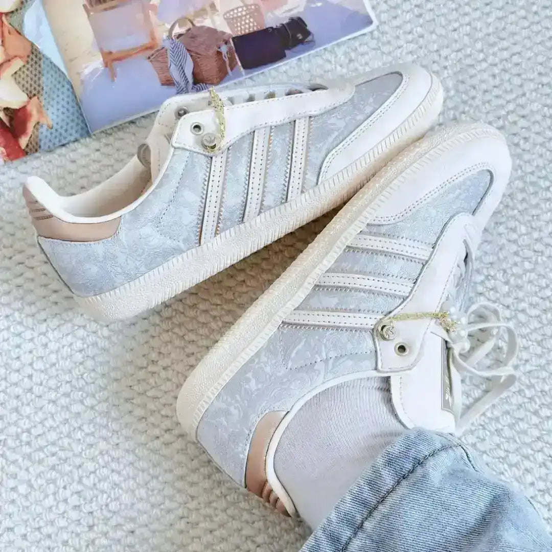 Beige Adidas leather sneakers with pearl and gold chain accessories, textured panel details and a stylish silhouette perfect for lifestyle outfits.