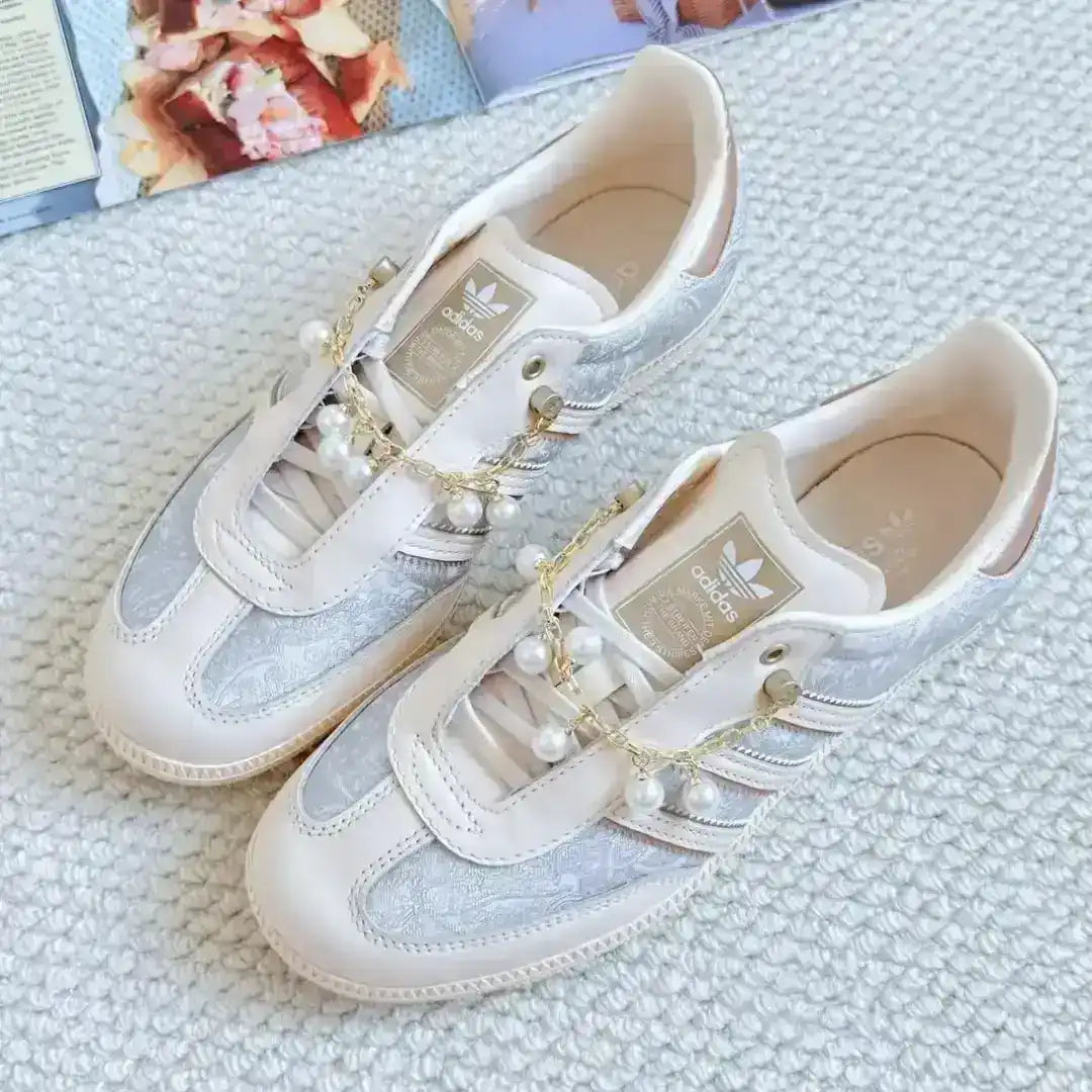 Adidas sneakers in beige featuring pearl chain decorations, textured material touches and a leather upper designed for premium comfort and style.