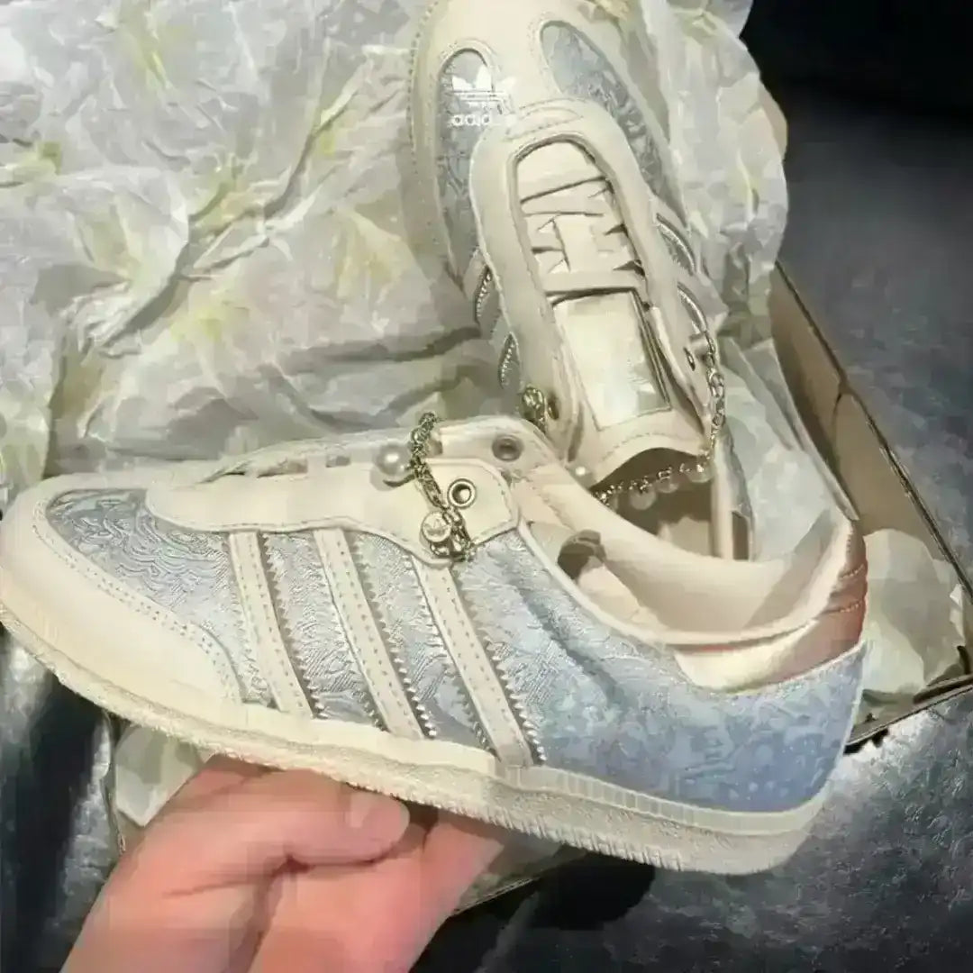 Women's Adidas Samba sneakers in off-white with lace details and pearl chains, unique footwear for casual chic denim styling looks today.