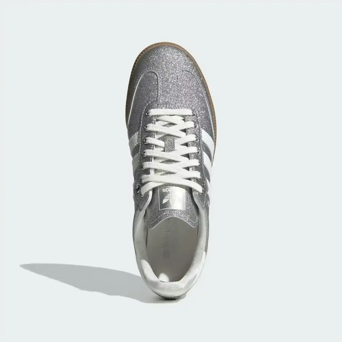 Low-top three-stripe sneakers with metallic-look panels, product views.