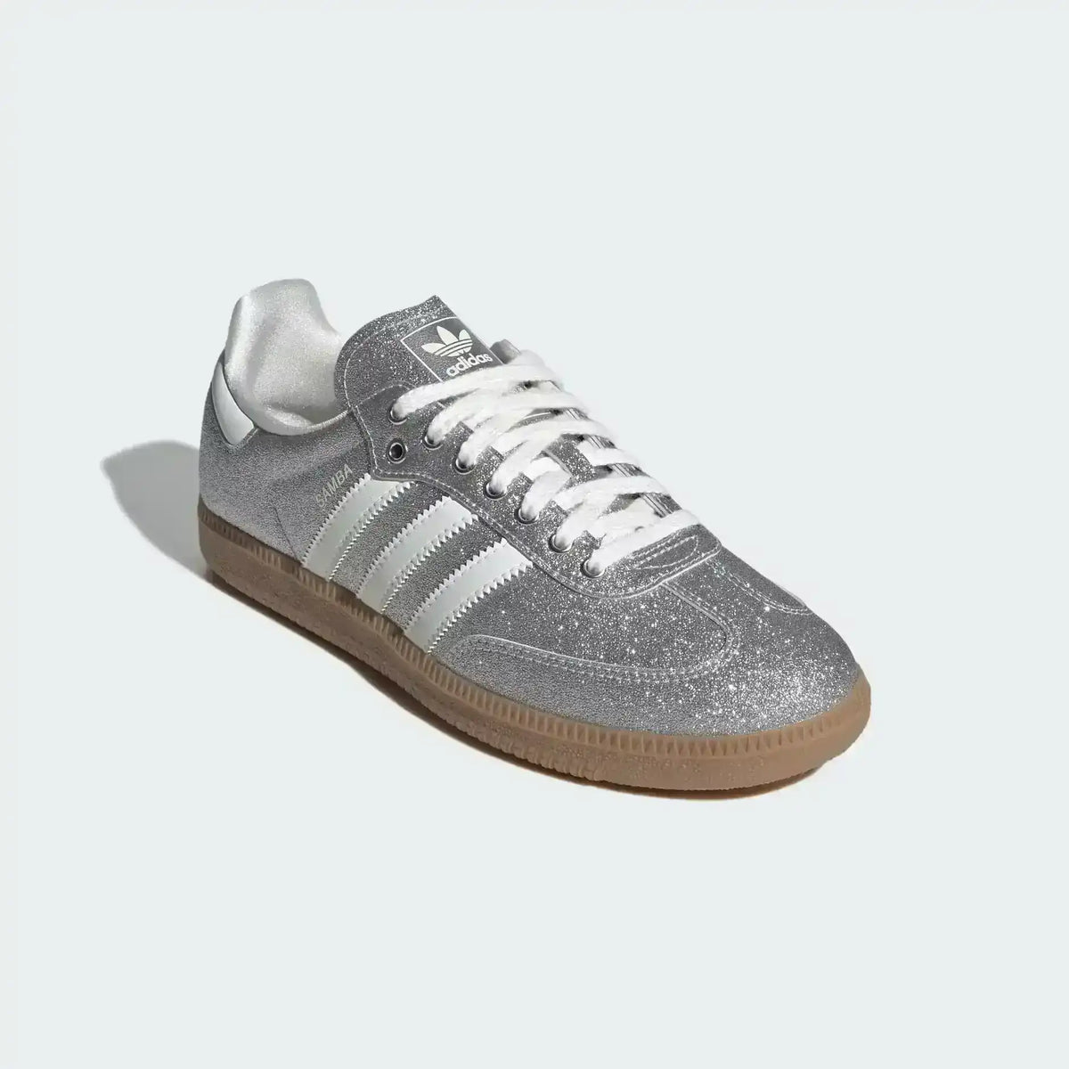 Low-top three-stripe sneakers with metallic-look panels, product views.