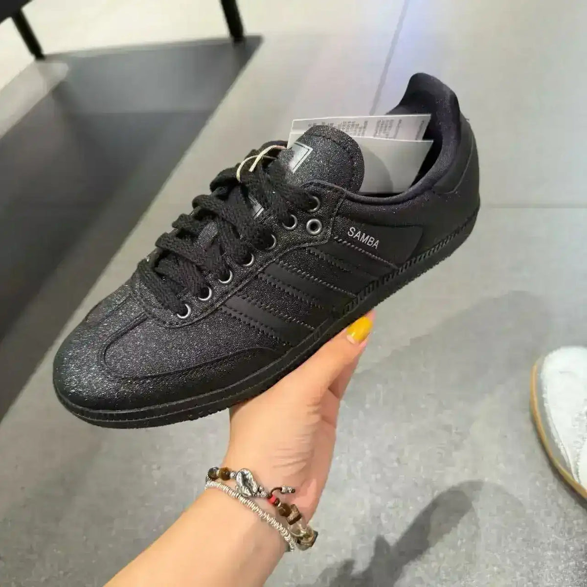 Low-top three-stripe sneakers with metallic-look panels, product views.