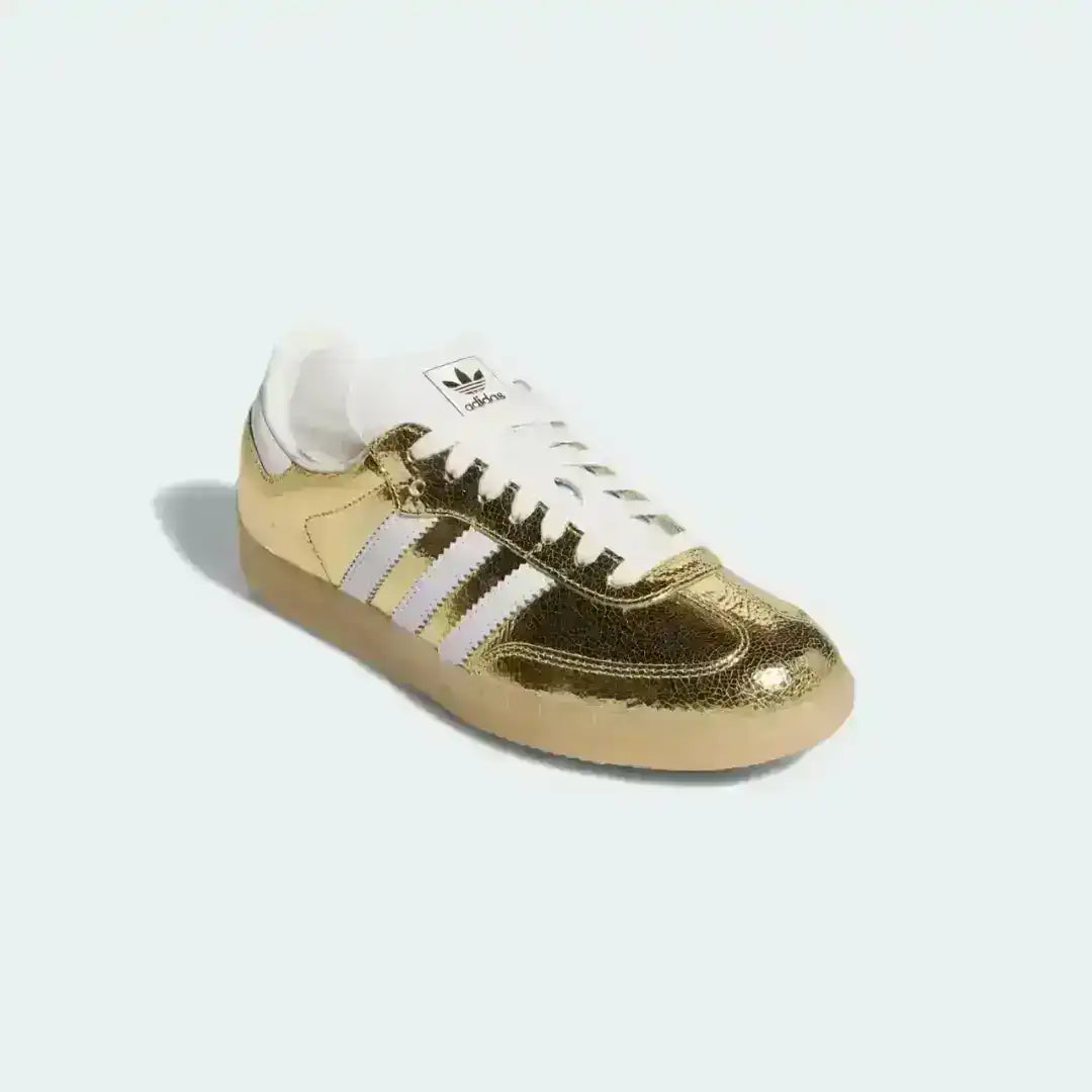 Adidas Samba OG Gold Metallic with shiny gold upper, white stripes and gum sole, premium lifestyle sneaker for bold fashion looks.
