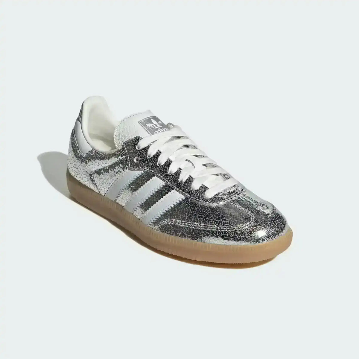 Low-top three-stripe sneakers with metallic-look panels, product views.