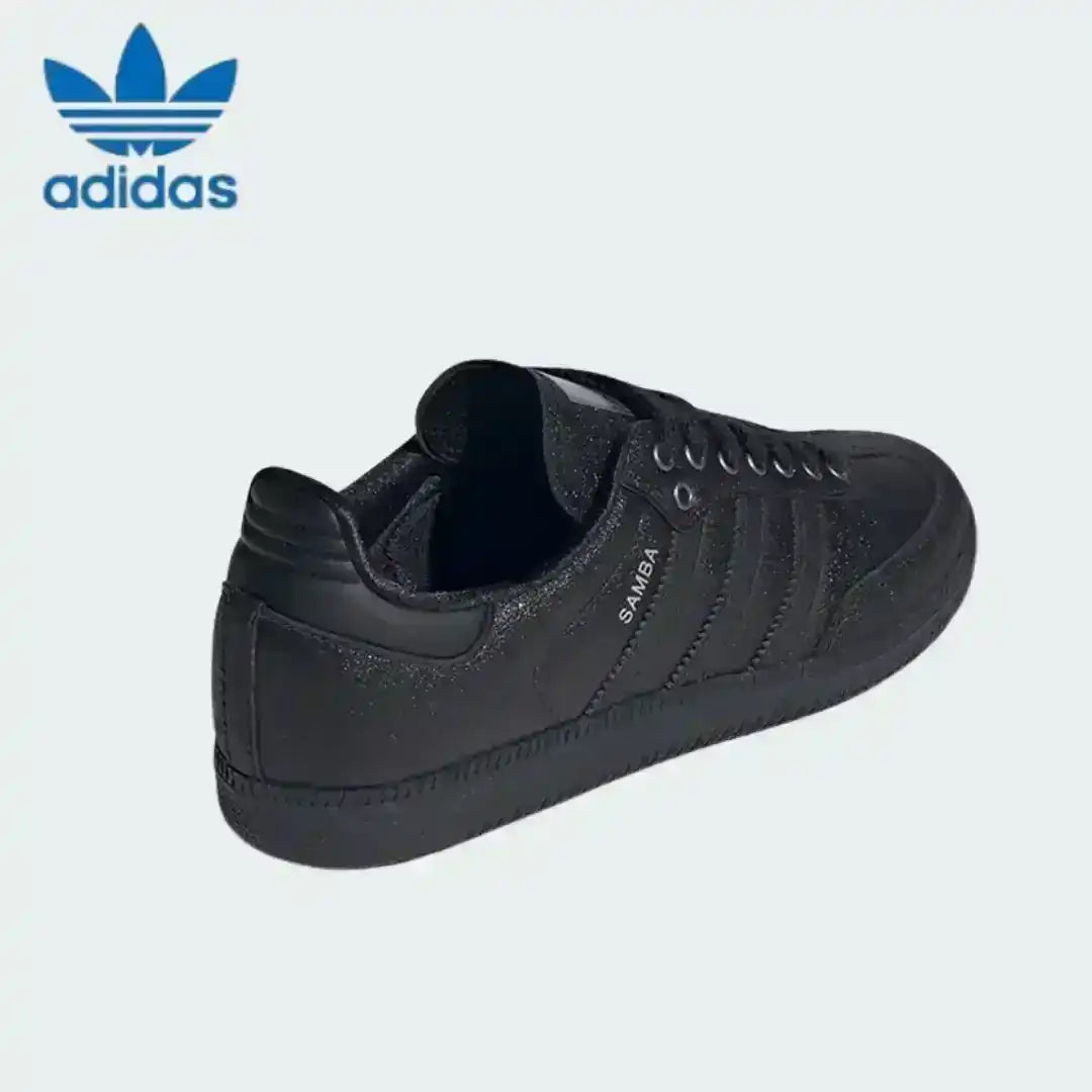 Sleek black Adidas Samba trainers with a matte, rough material effect on the upper, offering a premium twist on the retro shoe style.