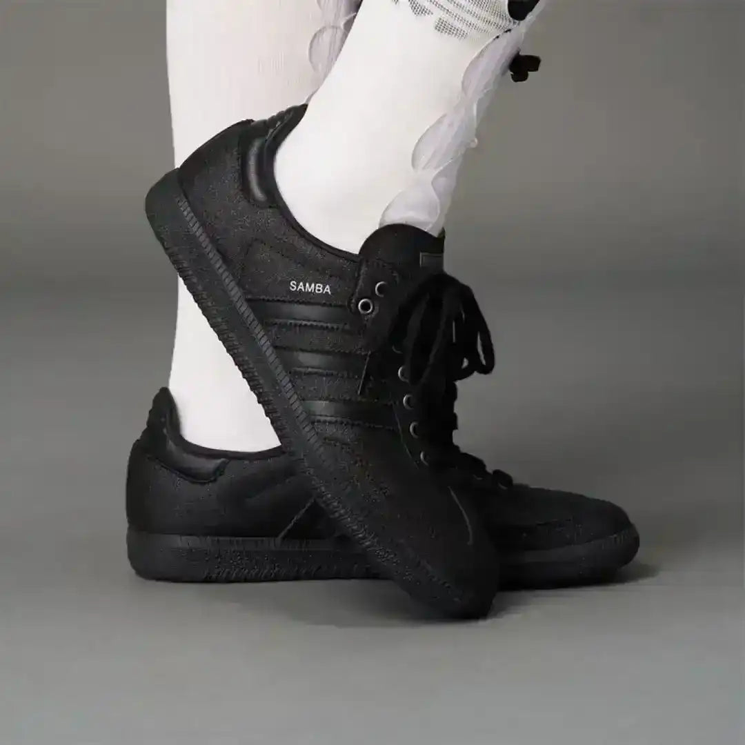 Aesthetic dark Adidas Samba sneakers featuring a deep black coarse surface, trending footwear choice for edgy fashion Pinterest boards.
