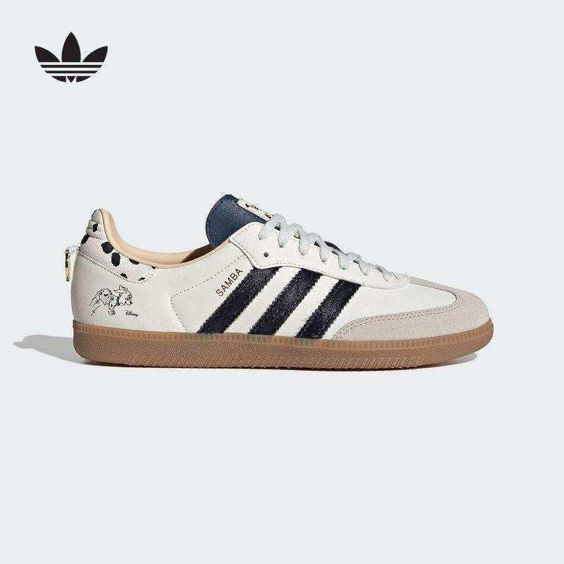 Cream three-stripe low-top sneakers with patterned heel details.