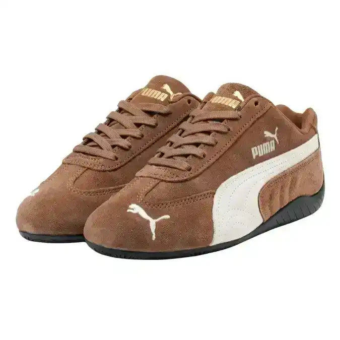 Brown low-profile lace-up sneakers with cream curved side stripes.