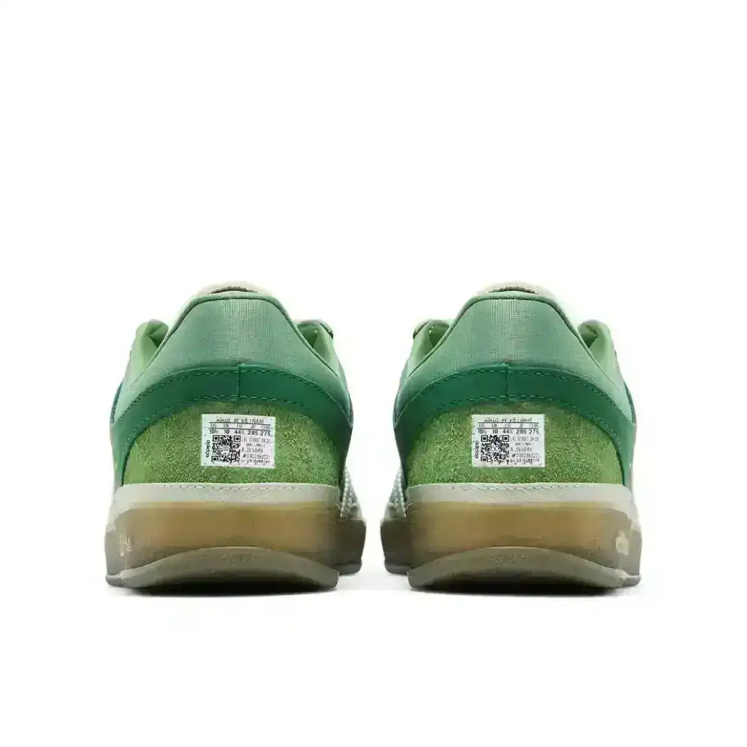 Green three-stripe low-top sneakers with gum soles.