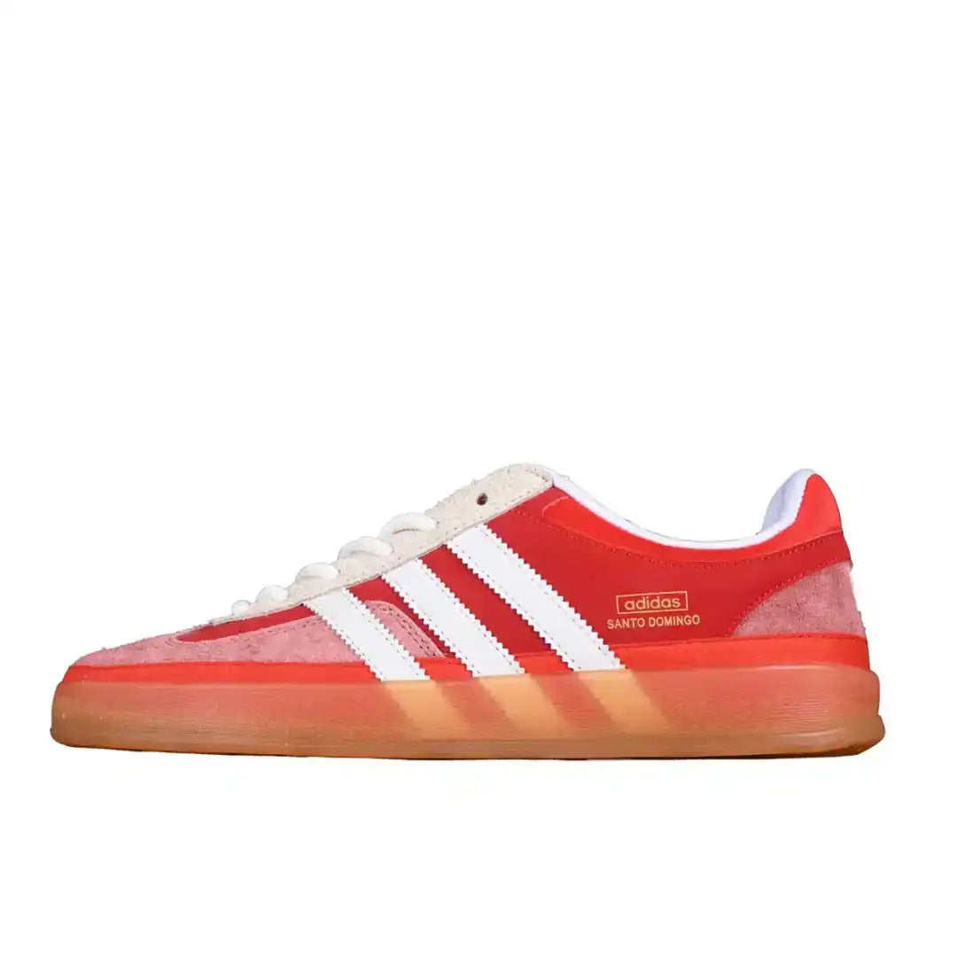 Red Adidas sneaker with white stripes on a white background