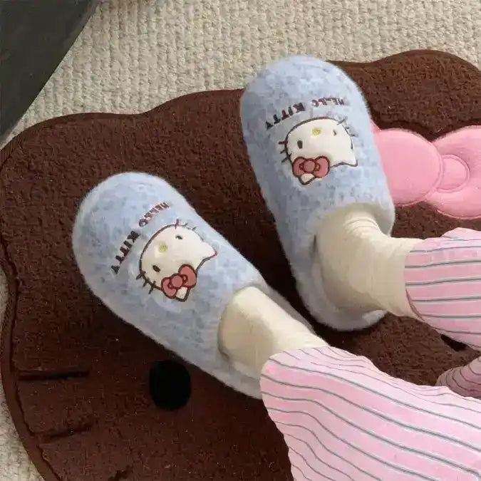 Fuzzy slip-on slippers decorated with a cat-face character.