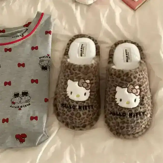 Fuzzy slip-on slippers decorated with a cat-face character.