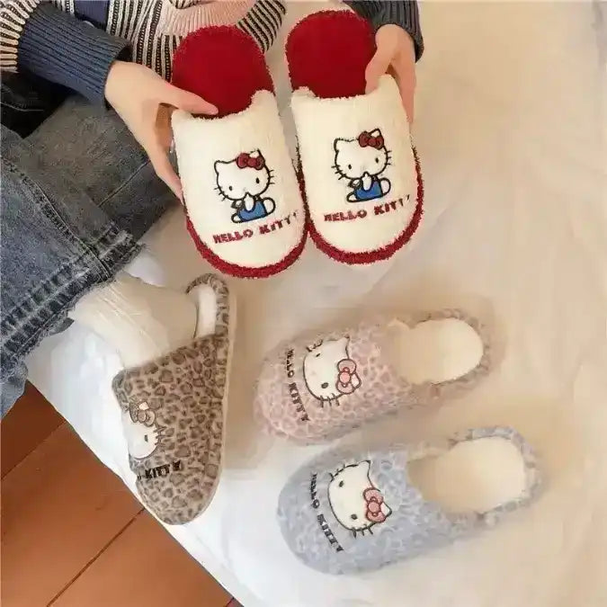 Fuzzy slip-on slippers decorated with a cat-face character.