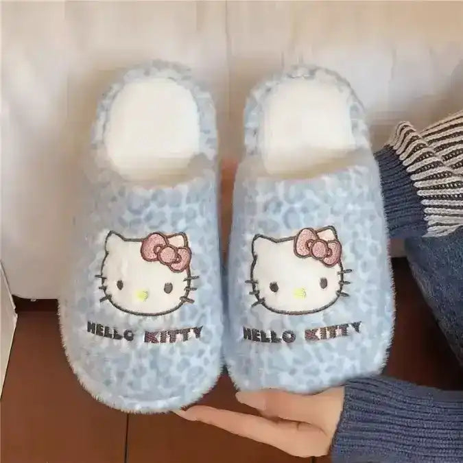 Fuzzy slip-on slippers decorated with a cat-face character.