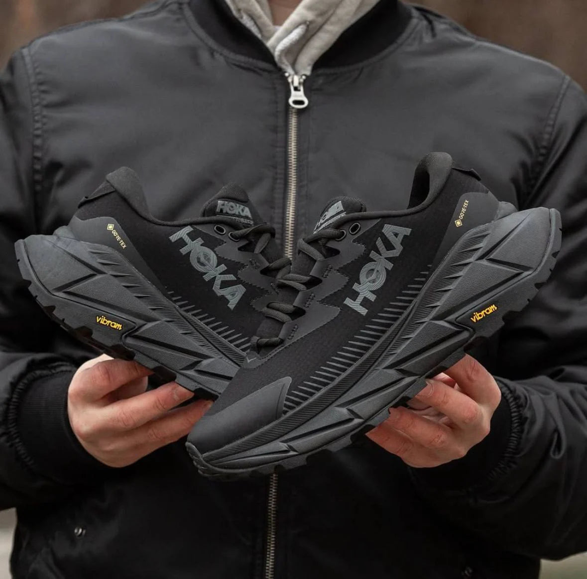 Detail view of Hoka Skyline-Float X breathable mesh upper and rugged outsole texture in all-black