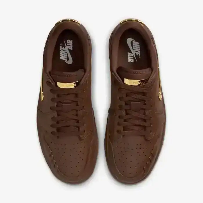 Low-top sneakers with gold-colored swoosh details, product views.