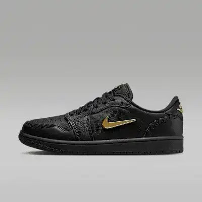 Black low-top sneakers with gold-colored swoosh details.