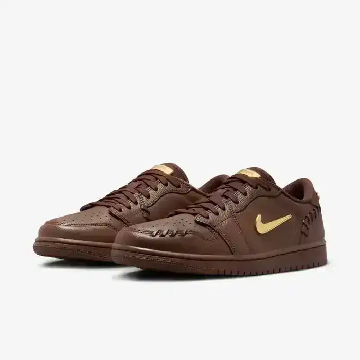 Low-top sneakers with gold-colored swoosh details, product views.