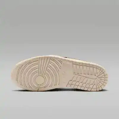 Cream sneaker outsole with circular tread, bottom view.
