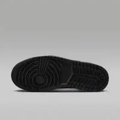Black sneaker outsole with circular tread, bottom view.