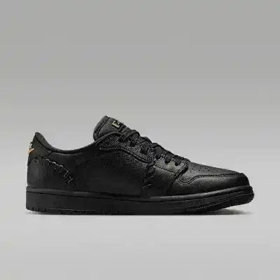 Black low-top sneakers with gold-colored swoosh details.
