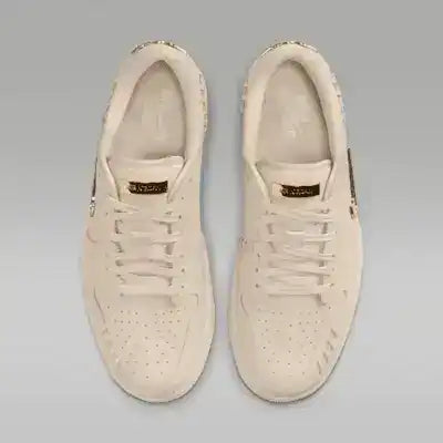 Cream low-top sneakers with swoosh details and tonal soles.