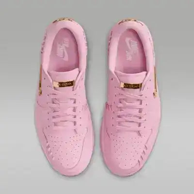 Pink low-top sneakers with gold-colored swoosh details.
