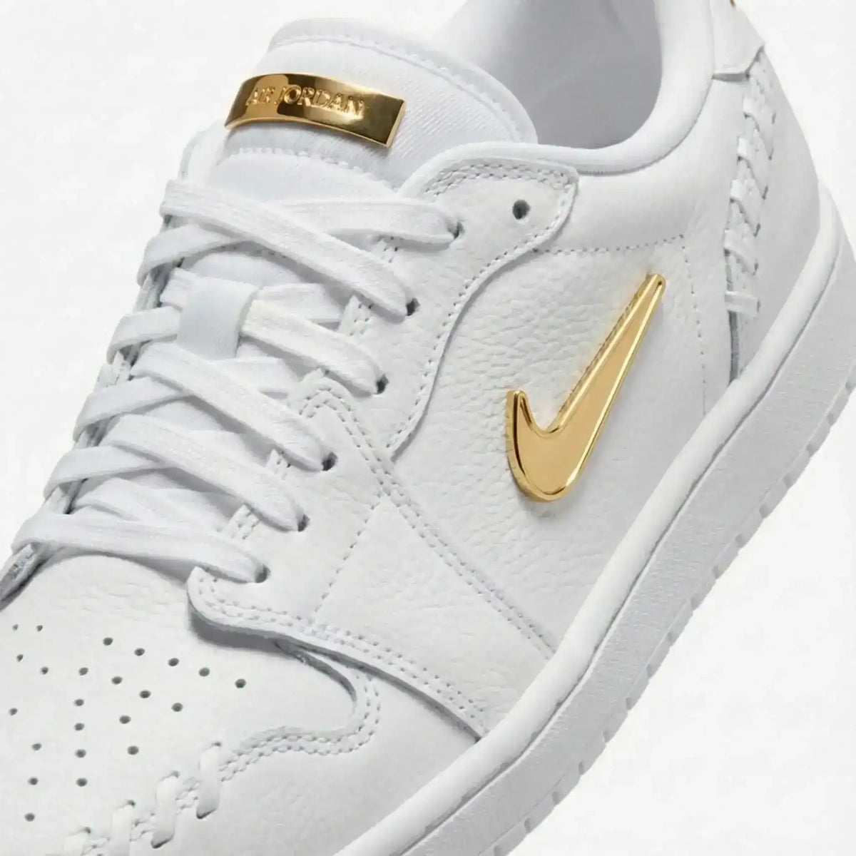 Swoosh-detail low-top sneakers, close-up and styling views.