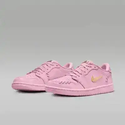 Pink low-top sneakers with gold-colored swoosh details.