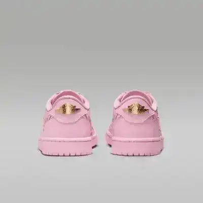 Pink low-top sneakers with gold-colored swoosh details.