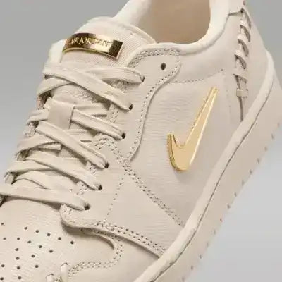 Low-top sneakers with gold-colored swoosh details, product views.