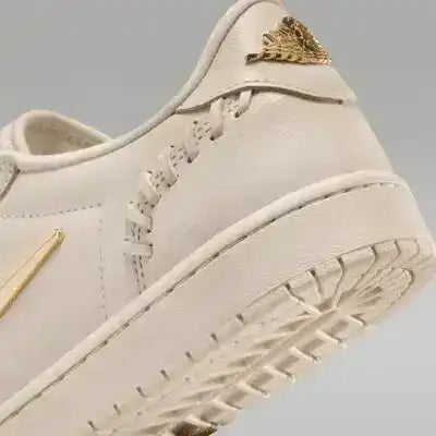 Low-top sneakers with gold-colored swoosh details, product views.