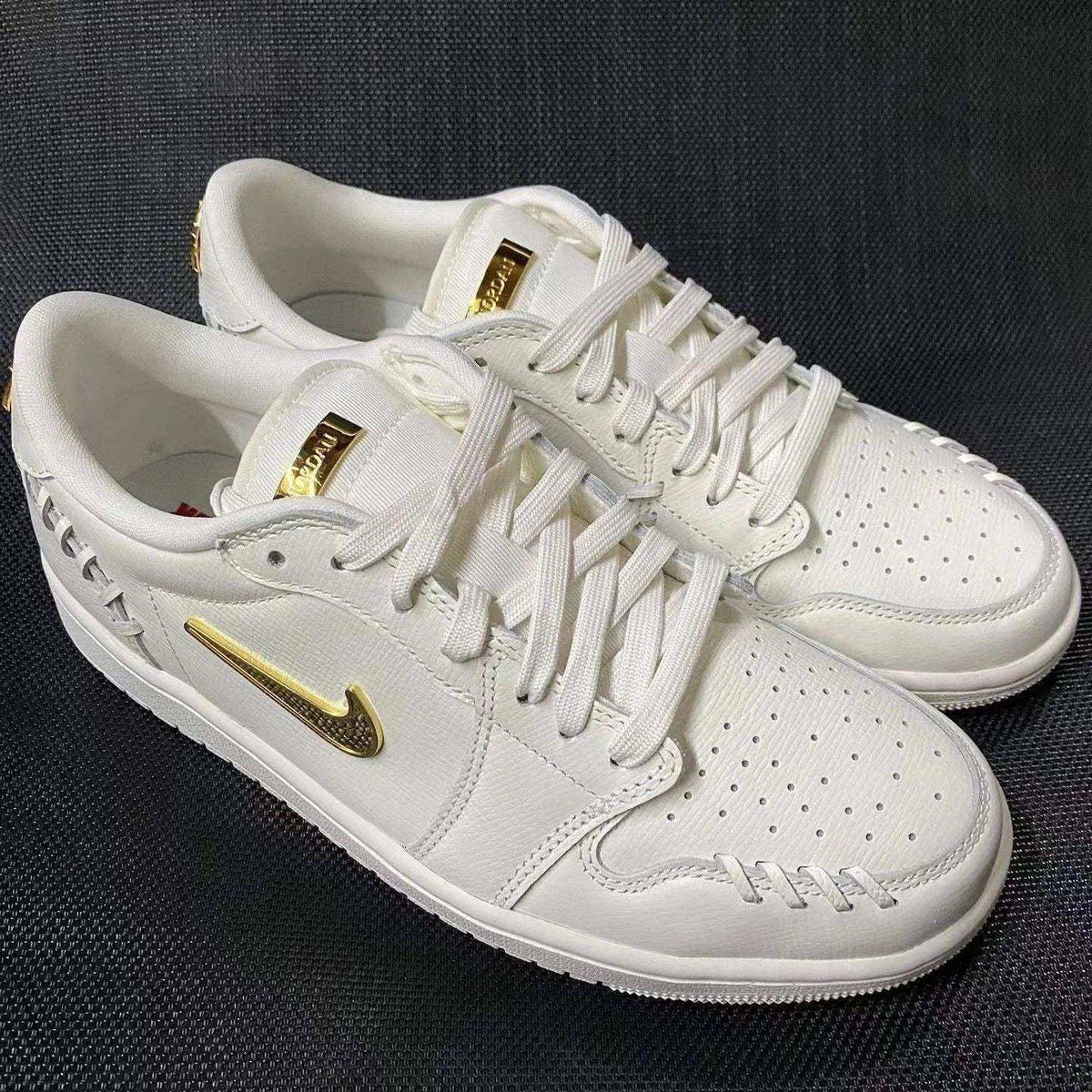 Swoosh-detail low-top sneakers, close-up and styling views.