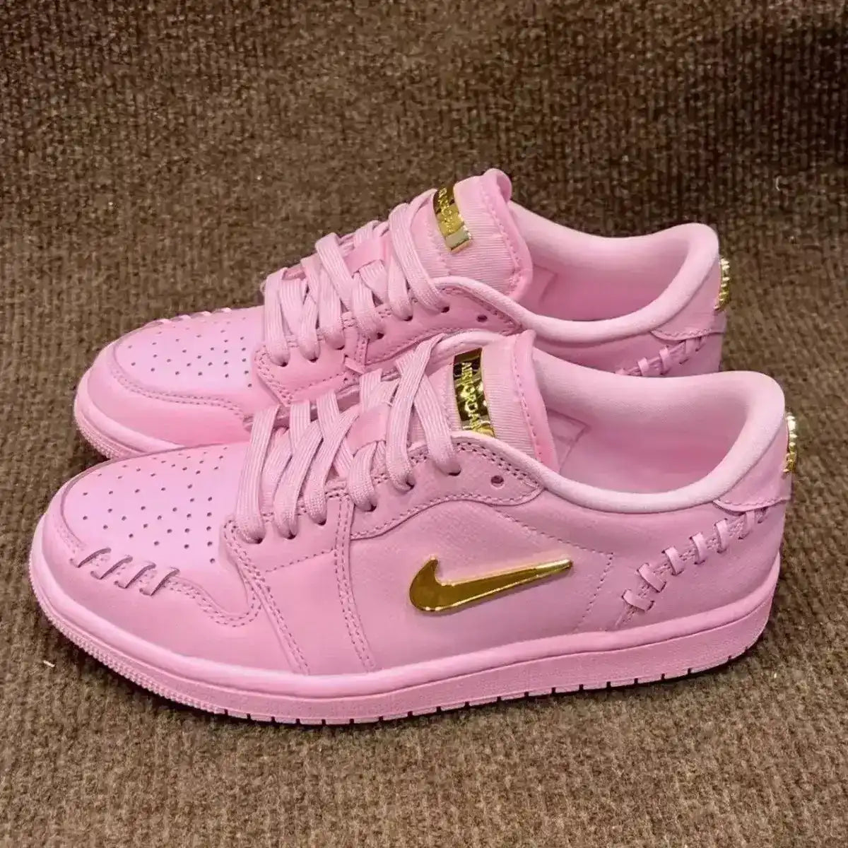 Swoosh-detail low-top sneakers, close-up and styling views.