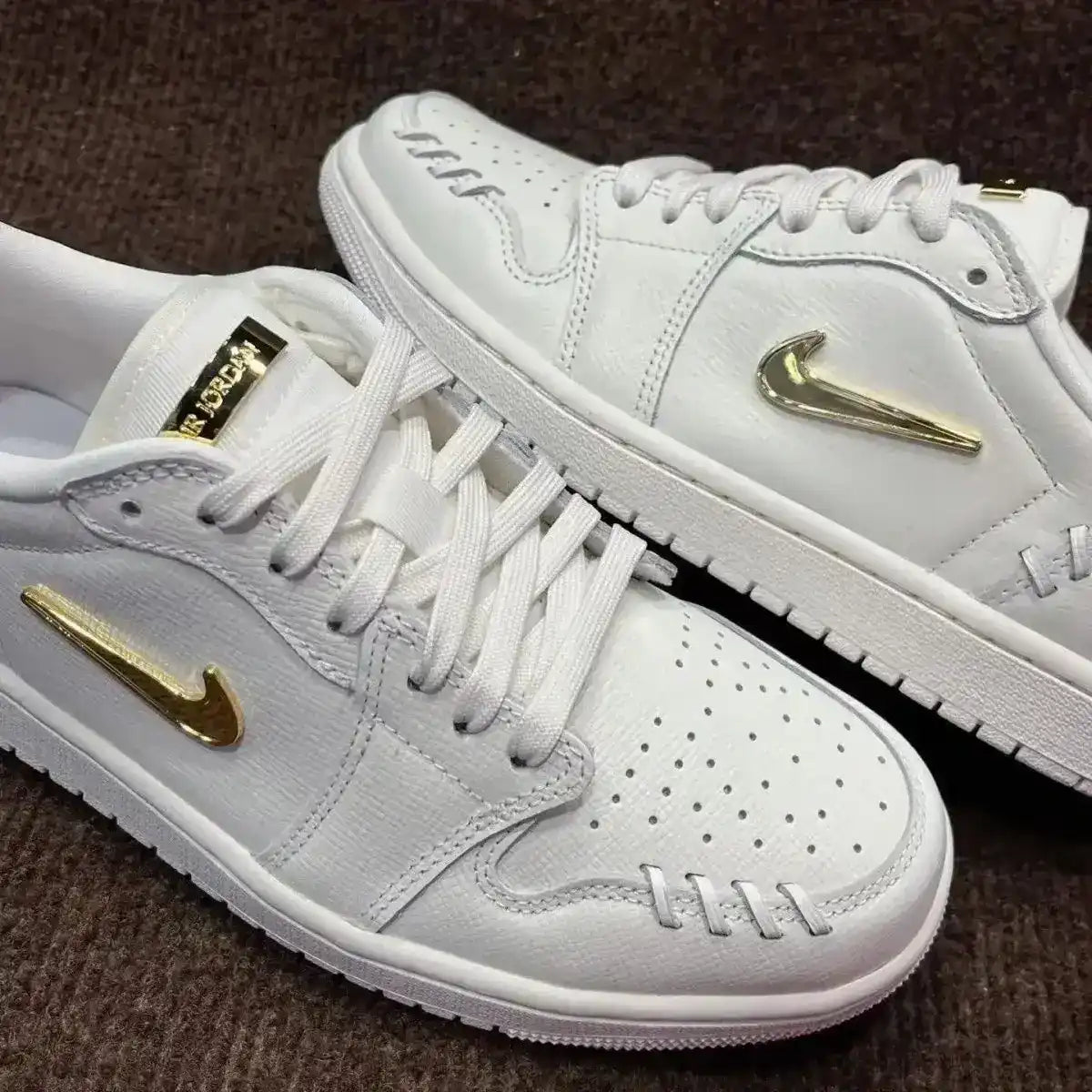 Swoosh-detail low-top sneakers, close-up and styling views.