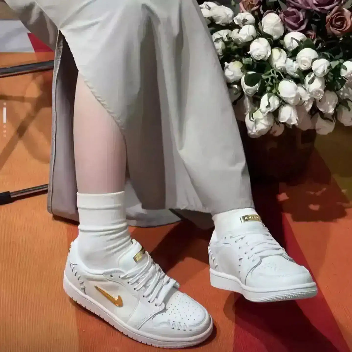 Swoosh-detail low-top sneakers, close-up and styling views.