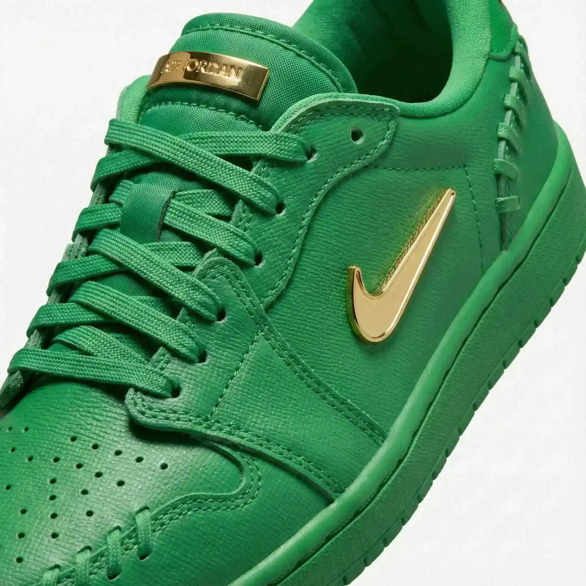 Swoosh-detail low-top sneakers, close-up and styling views.