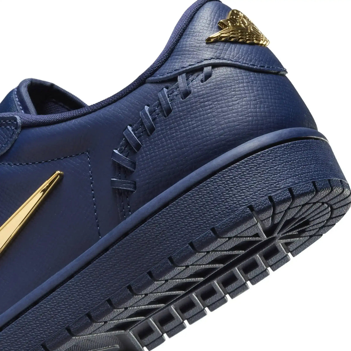 Low-top sneakers with gold-colored swoosh details, product views.