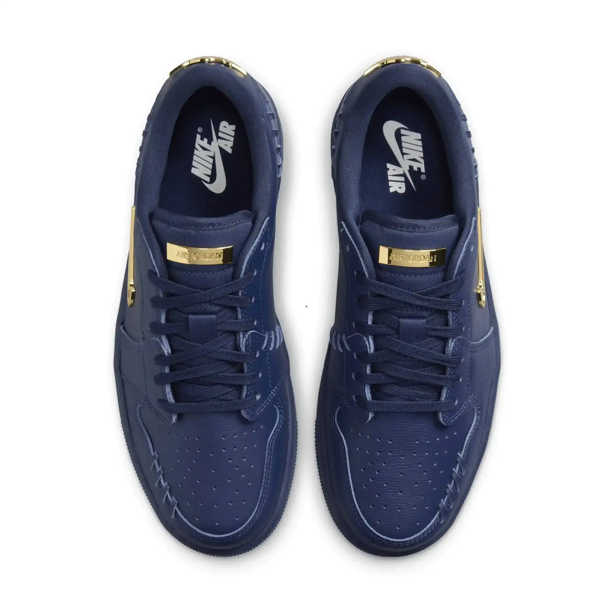 Navy low-top sneakers with gold-colored swoosh details.