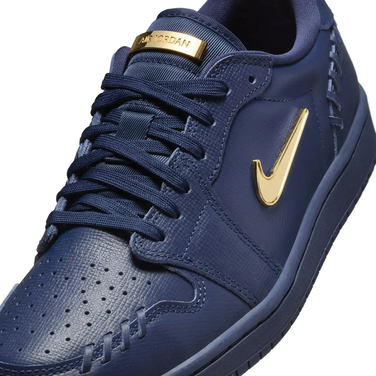 Low-top sneakers with gold-colored swoosh details, product views.