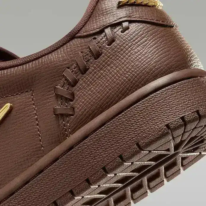 Low-top sneakers with gold-colored swoosh details, product views.